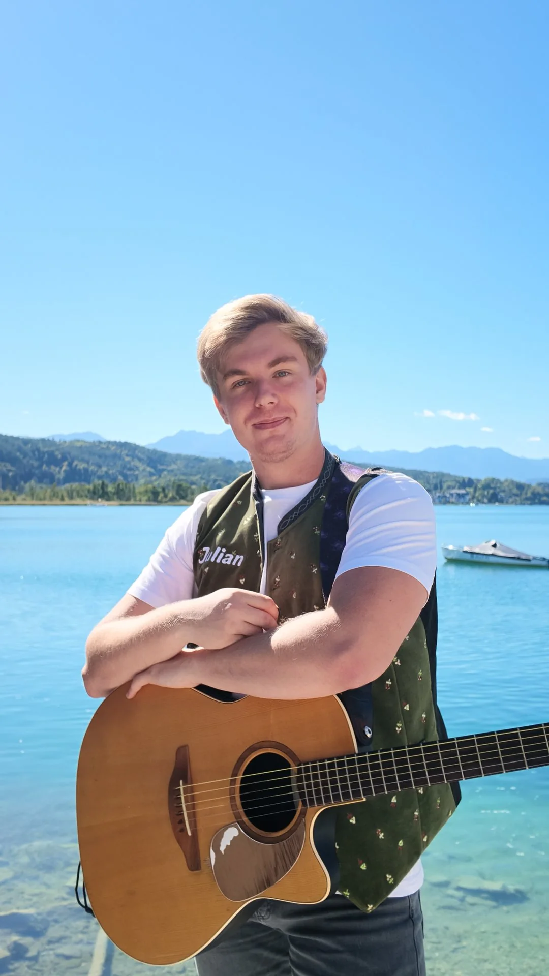 Julian mit der Gitarre am See